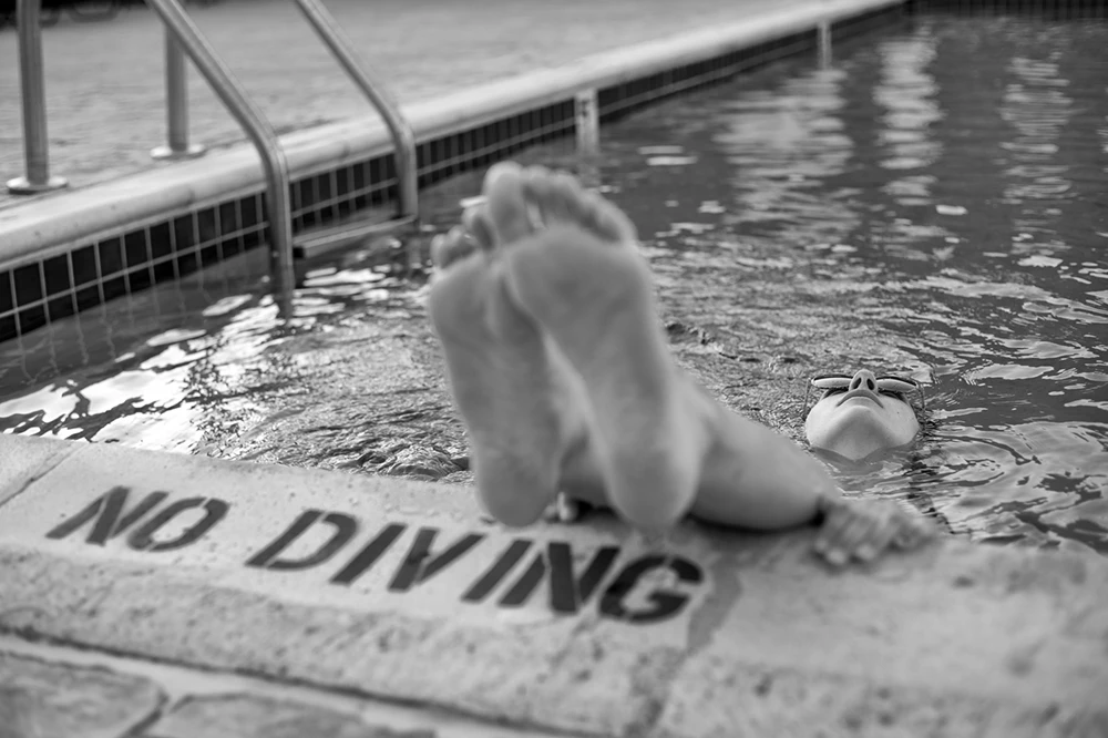 Woman floating in swimming pool